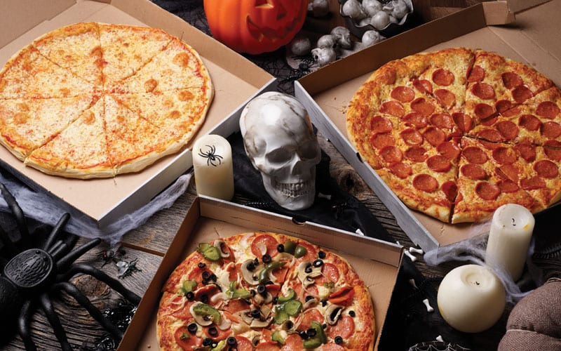 spooky pizza with skull, spider, and candles